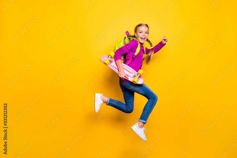 Full length body size view of her she nice attractive lovely glad cheerful cheery girl jumping running carrying skateboard isolated over bright vivid shine vibrant yellow color background Full length body size view of her she nice attractive lovely glad cheerful cheery girl jumping running carrying skateboard isolated over bright vivid shine vibrant yellow color background