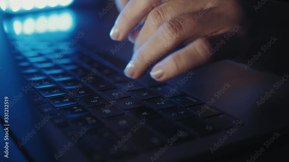 close up of hands of business person or gamer working on computer, man using internet and social media blue neon light close up of hands of business person or gamer working on computer, man using internet and social media blue neon light