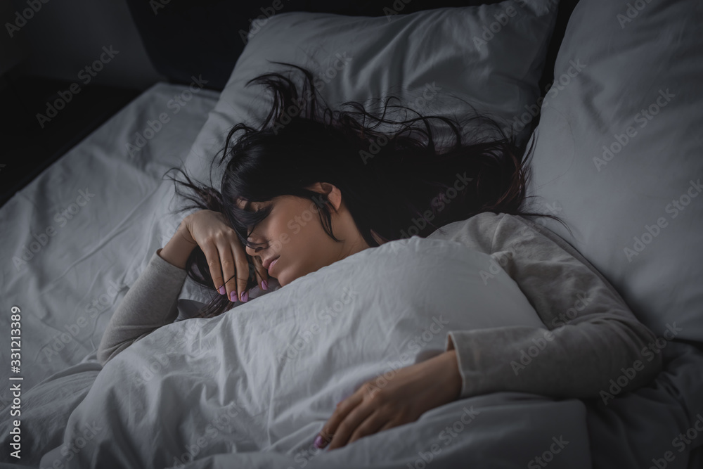 displeased woman having insomnia while lying on bed at night displeased woman having insomnia while lying on bed at night