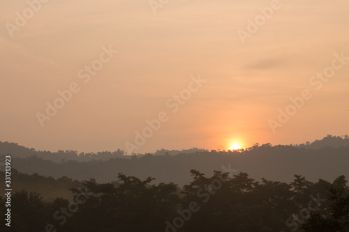 Fototapeta Naklejka Na Ścianę i Meble -  sunrise among trees with a dense fog at Jedkod-Pongkonsao Natural Study in Saraburi Thailand	