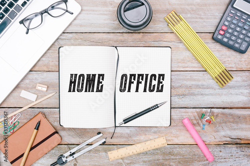 Home Office written in notepad on table, pencil for writing, grunge office deskt flat lay shot from above photo