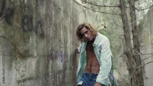 Slow motion shot of young man walking between walls