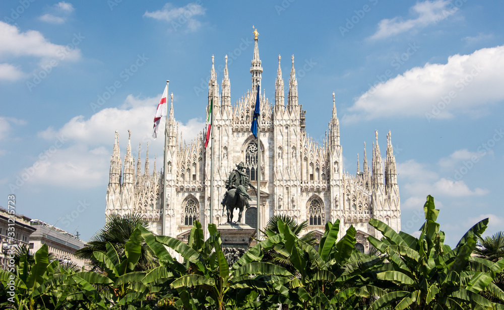 Duomo di milano blue sky european flags trees in front Duomo di milano blue sky european flags trees in front