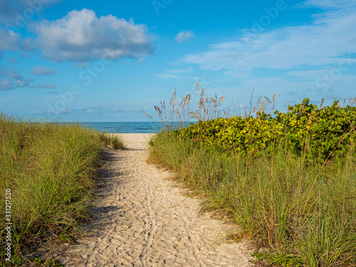 Sandy path to Nokomis Beach on Gulf of Mexico in early morning light on Casey Key in Nokomis Florida in the United States
