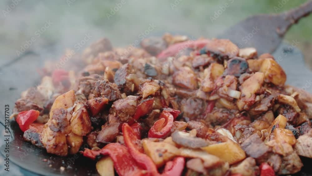 cooking food in the nature. cooking meat on fire in mountains. vacation in the mountains cooking food in the nature. cooking meat on fire in mountains. vacation in the mountains