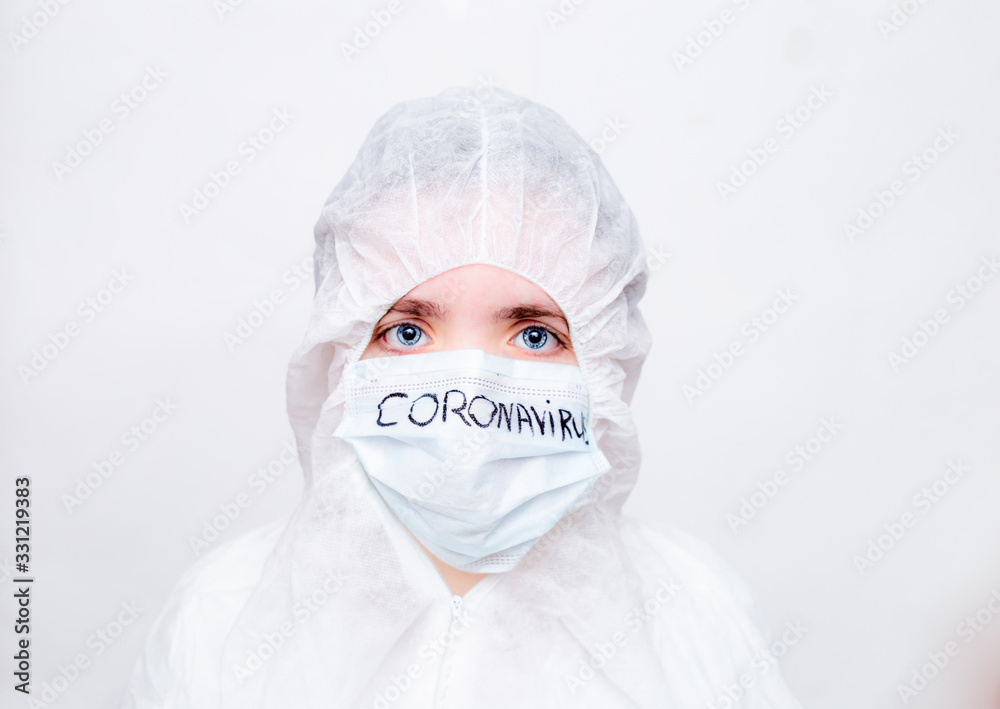 A virologist in a white mask and rubber gloves in a viral protective suit holds his head , looks fearfully at the camera and thinks about how to stop the coronavirus epidemic and what to do. The fear A virologist in a white mask and rubber gloves in a viral protective suit holds his head , looks fearfully at the camera and thinks about how to stop the coronavirus epidemic and what to do. The fear