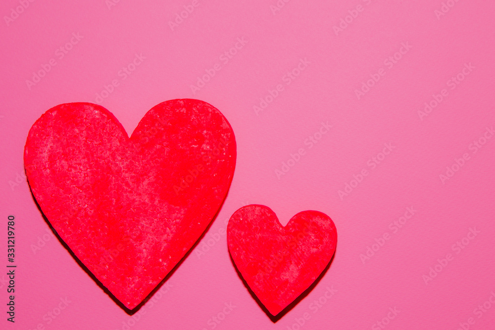 Two red hearts on pink background. The Symbols Of Love. Valentine's Day Concept.