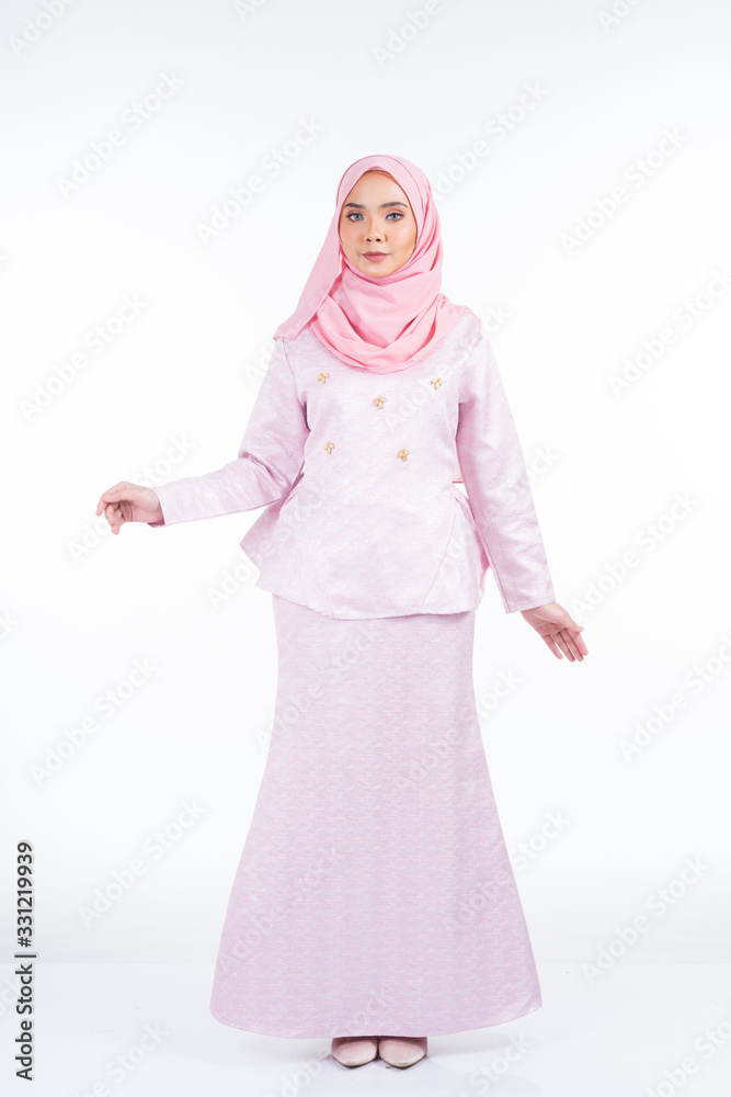 Full length portrait of a beautiful female model wearing traditional dress and hijab, a lifestyle apparel for Muslim women isolated on white background. Idul Fitri and hijab fashion concept. Full length portrait of a beautiful female model wearing traditional dress and hijab, a lifestyle apparel for Muslim women isolated on white background. Idul Fitri and hijab fashion concept.