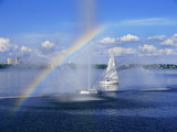  Lone sailboat on the river near the fountain in the rainbow