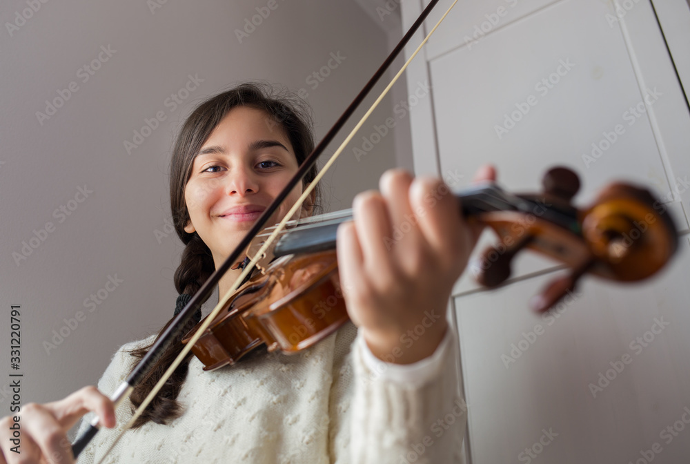 Young smiling girl student practice violin at home Young smiling girl student practice violin at home