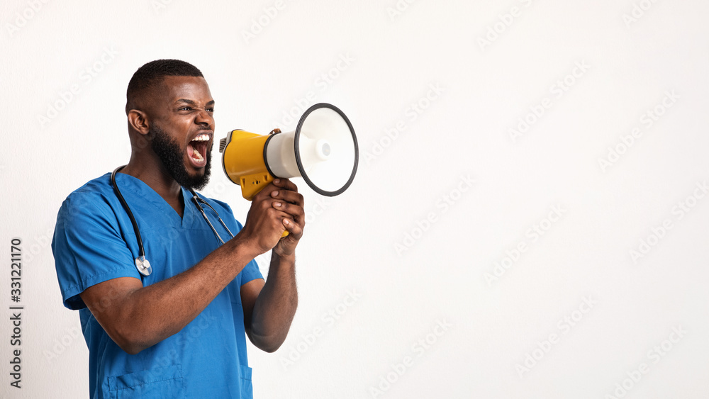 Angry black doctor in blue uniform using speaker Angry black doctor in blue uniform using speaker