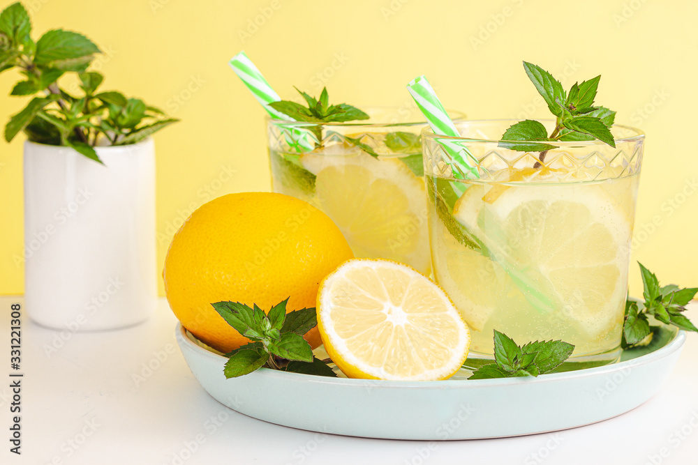 Lemon lemonade in mason jar glass ofwith lemons and straw on tab Lemon lemonade in mason jar glass ofwith lemons and straw on tab