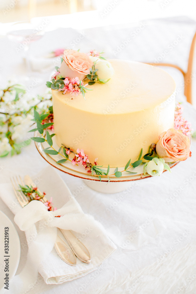 Yellow wedding cake with flowers Yellow wedding cake with flowers