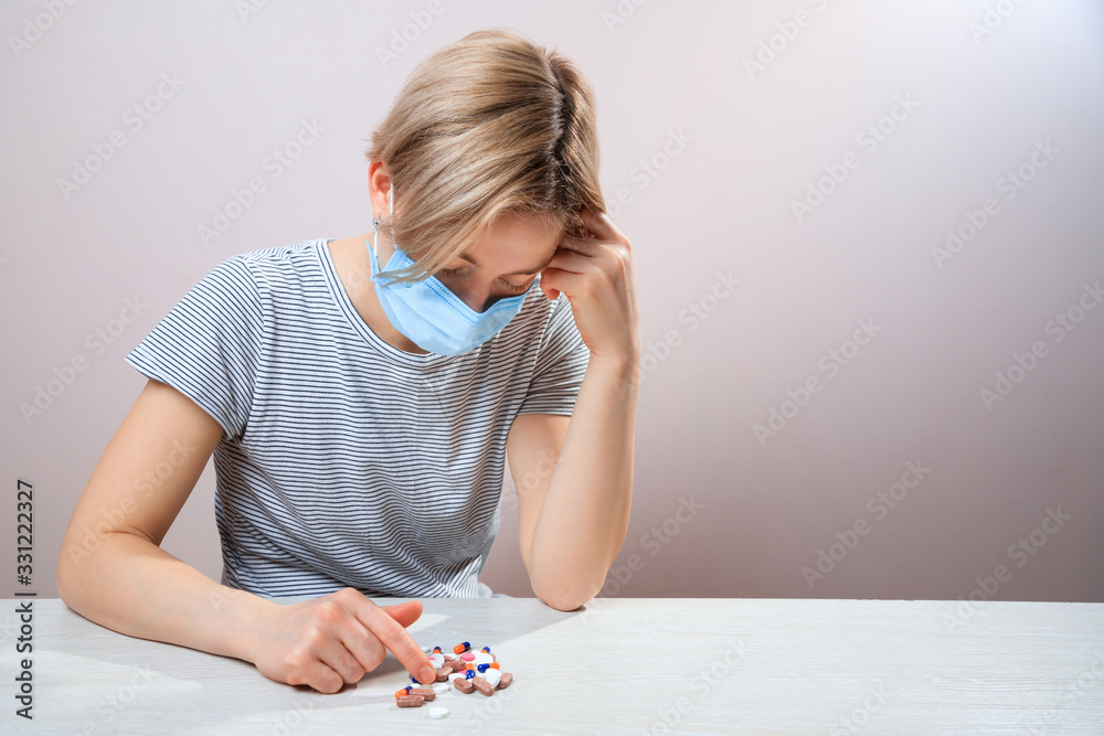 Girl with mask to protect her from Corona virus. Corona virus pandemic. Woman taking lot of white pills Girl with mask to protect her from Corona virus. Corona virus pandemic. Woman taking lot of white pills