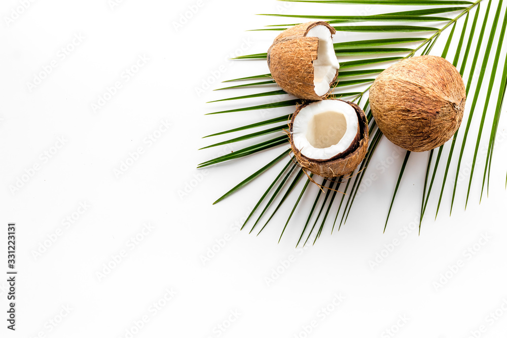 Coconuts and leaves - tropical still life on white background top-down copy space Coconuts and leaves - tropical still life on white background top-down copy space