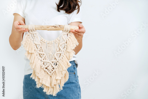 Closeup hand of girl, she shows macrame photo