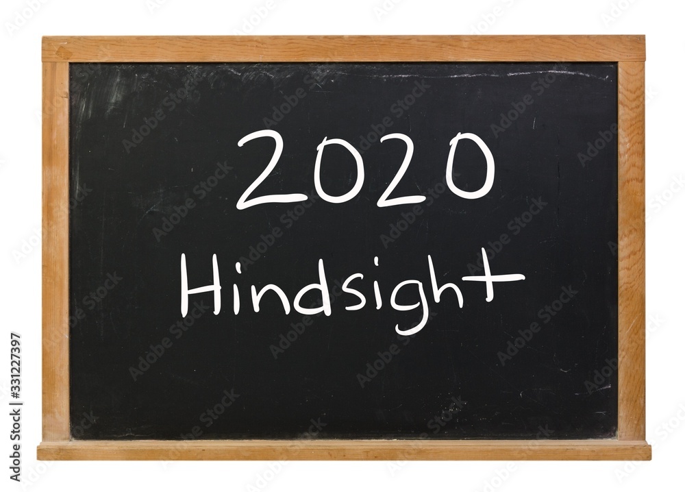 2020 Hindsight written in white chalk on a black chalkboard isolated on white