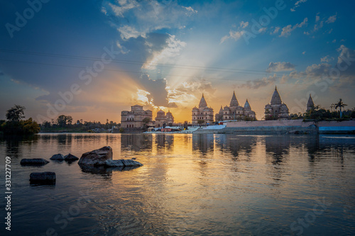 Sunset view of chhatri or canopies at Orchha from across the betwa river in Orchha Madhya Pradesh India.