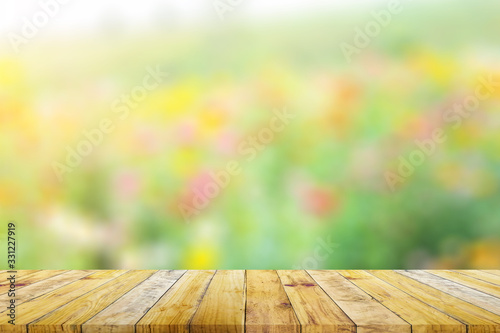 Shelf of Brown wood plank board with blurred green nature background.