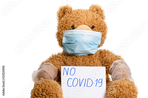 toy bear in a mask and gloves, a symbol of medicine against