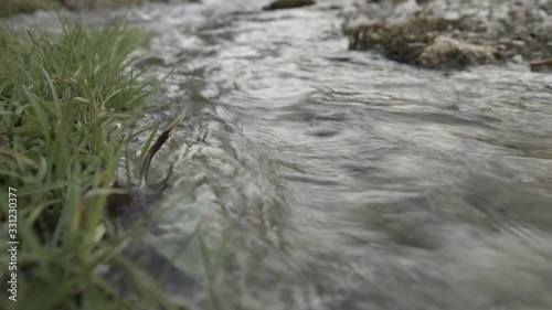 close-up of  a stream of water splashing in the vegetation in Urlatoarea. photo