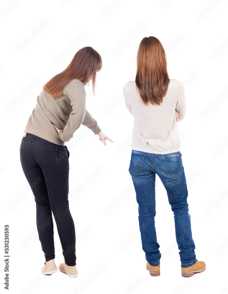 Back view of two pointing girl in sweater. Back view of two pointing girl in sweater.