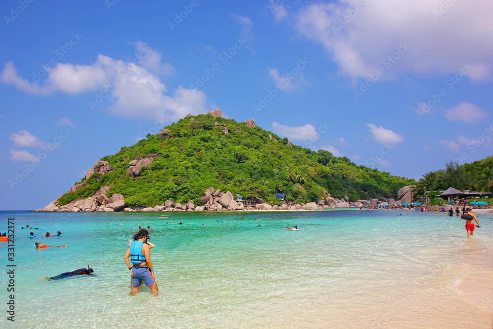 tourist with Nang YUAN island .foreigner tourists are enjoy relax sunbathe,dive,scuba,snorkeling at beautiful sea and the green island.