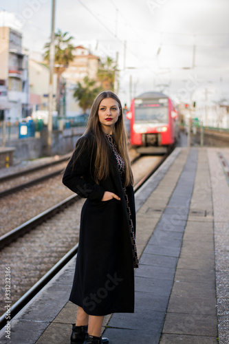 girl sitting on the bench waiting for the train © Tetiana Tuzyk