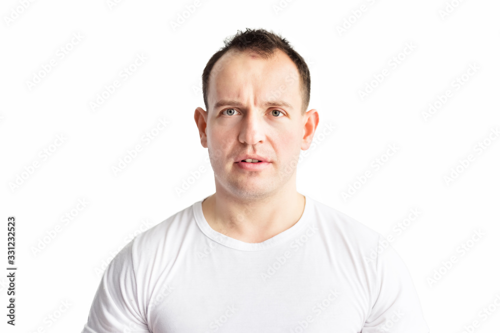 Obraz premium Portrait on handsome caucasian surprised man with disbelief and amusement on his face in white t-shirt isolated on white background. Emotions. Space for text