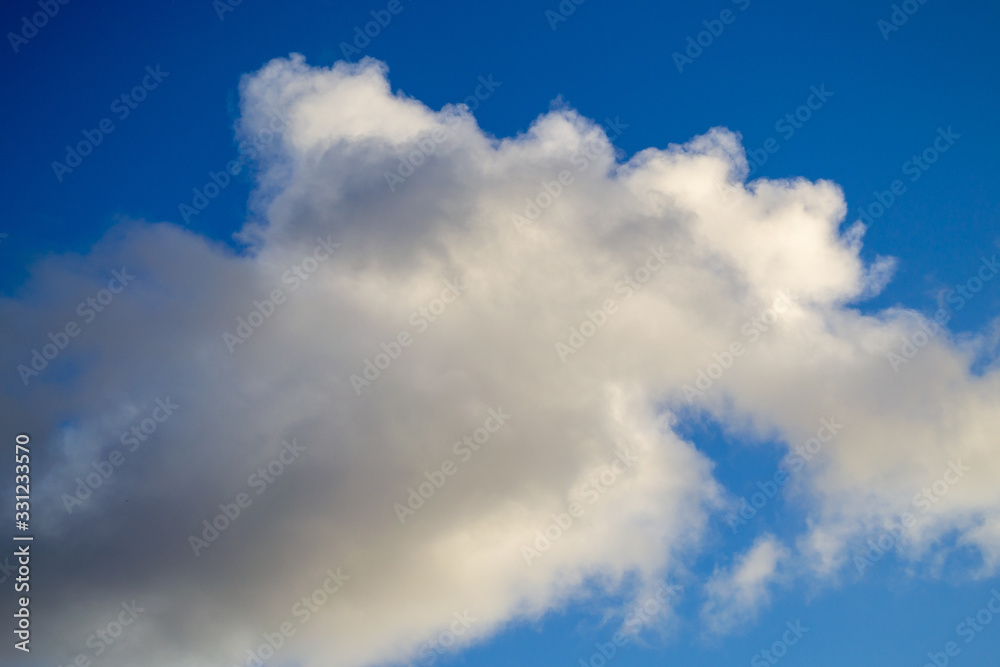 Bright white with grey clouds on blue sky. Beautiful background. Bright white with grey clouds on blue sky. Beautiful background.