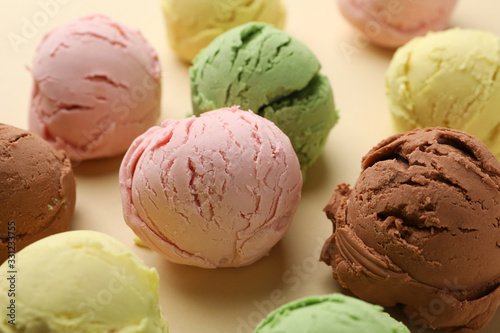 Ice cream balls on beige background, close up