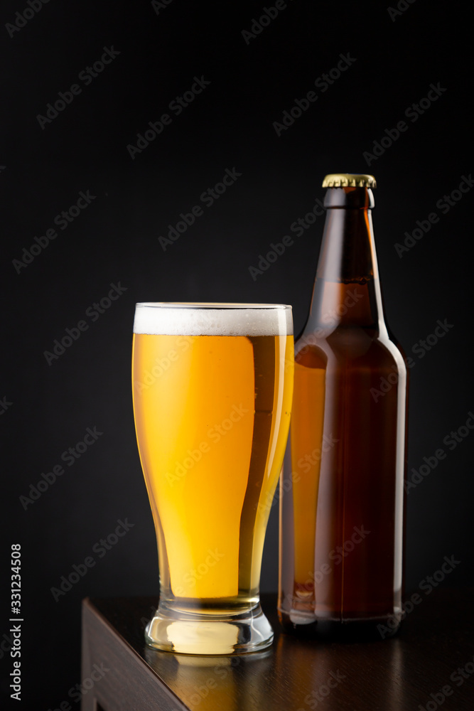 Beer glass and bottle on bar counter