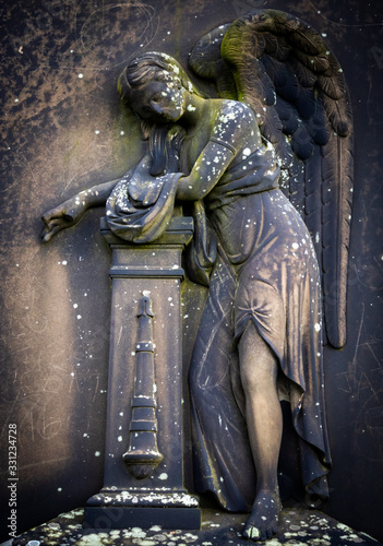 Sad angel carved from stone photo