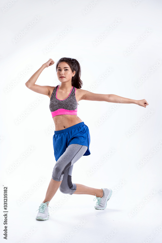 Young lady wearing exercise set twisted her body and kneel ,raise fists up in the air,show basic of dance workout,with happy feeling