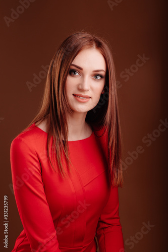 girl with long hair in red on dark background