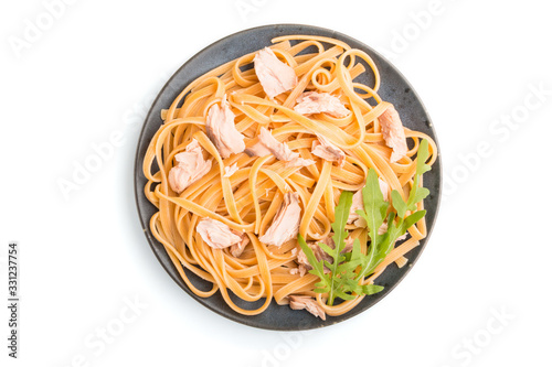 Semolina pasta with salmon isolated on white background. Top view, close up.