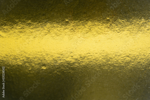 Metalic gold color, shiny reflective textured background