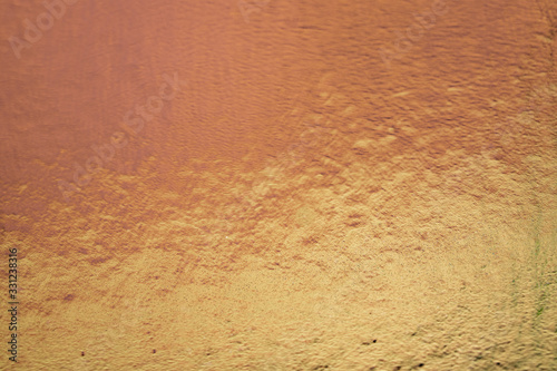 Metalic gold color, shiny reflective textured background