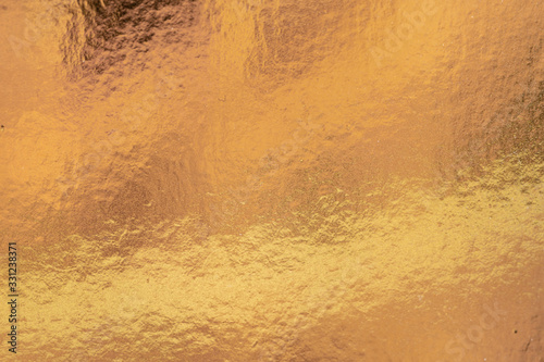 Metalic gold color, shiny reflective textured background
