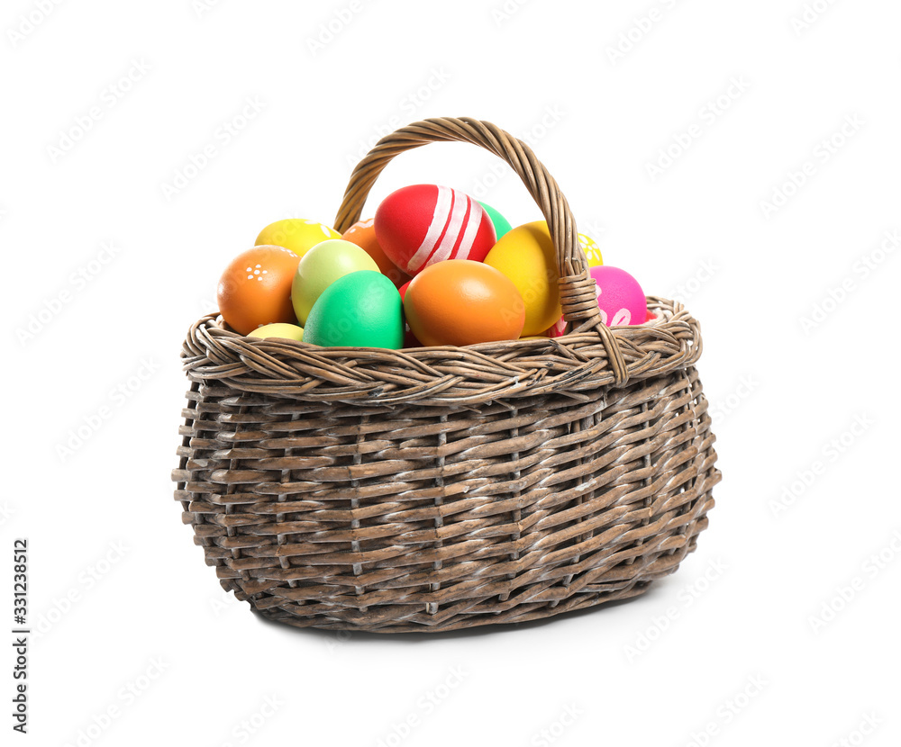 Bright Easter eggs in wicker basket isolated on white background Bright Easter eggs in wicker basket isolated on white background