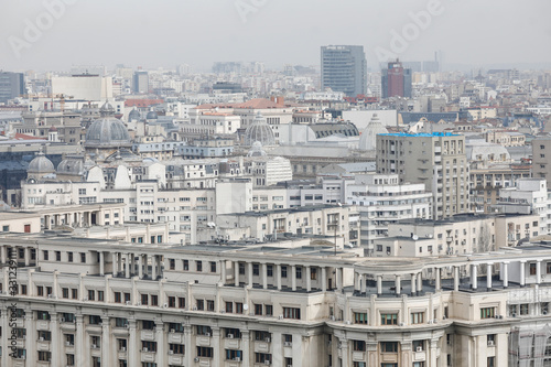 Overview of Bucharest as seen from the Palace of Parliament on a cloudy day.