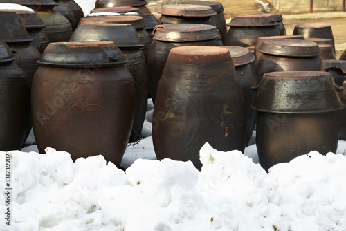 Korean traditional kimchi jars with snow in the foreground