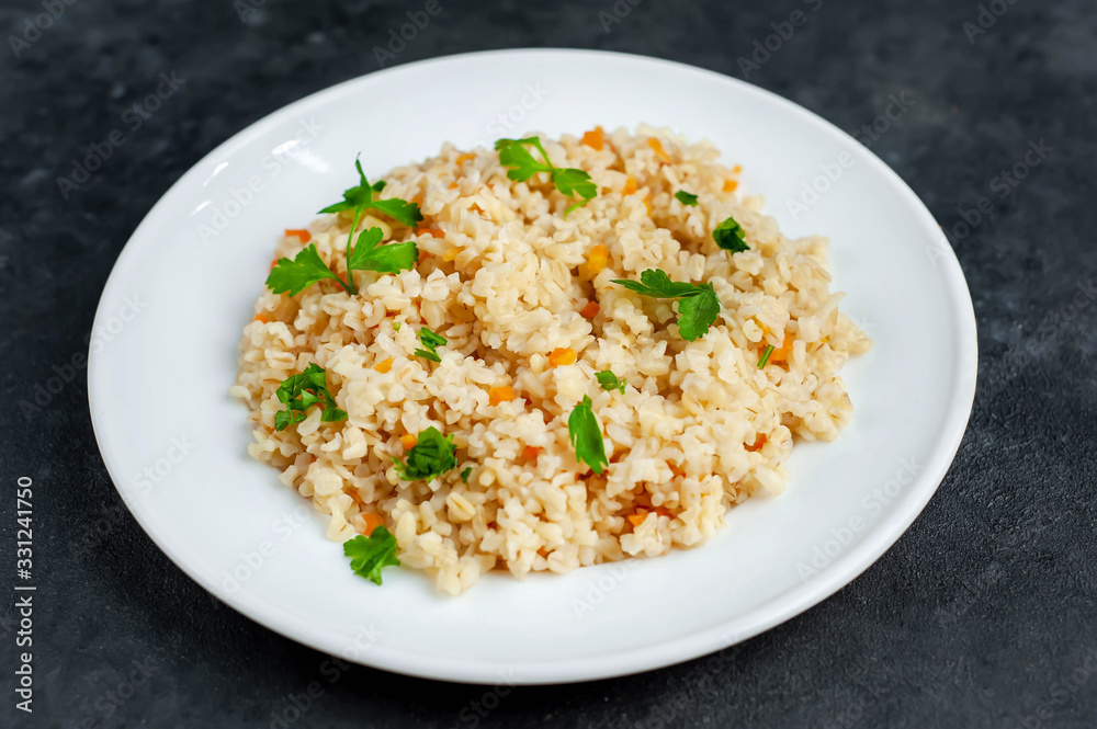 Bulgur with vegetables on a stone background. Healthy eating Bulgur with vegetables on a stone background. Healthy eating