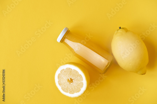 Vitamin c health remedy relief drink for cold and flu, with lemon and orange fruit, ginger and cinnamon spice and honey on yellow background
