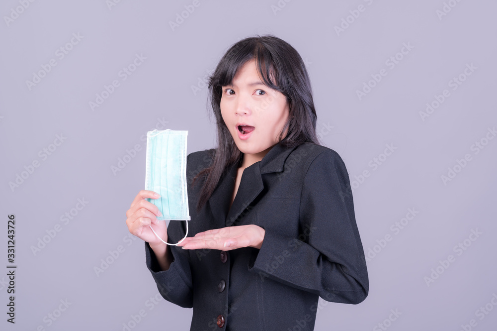 Asian business women have to use a mask to cover the face to prevent pollution from dust Asian business women have to use a mask to cover the face to prevent pollution from dust