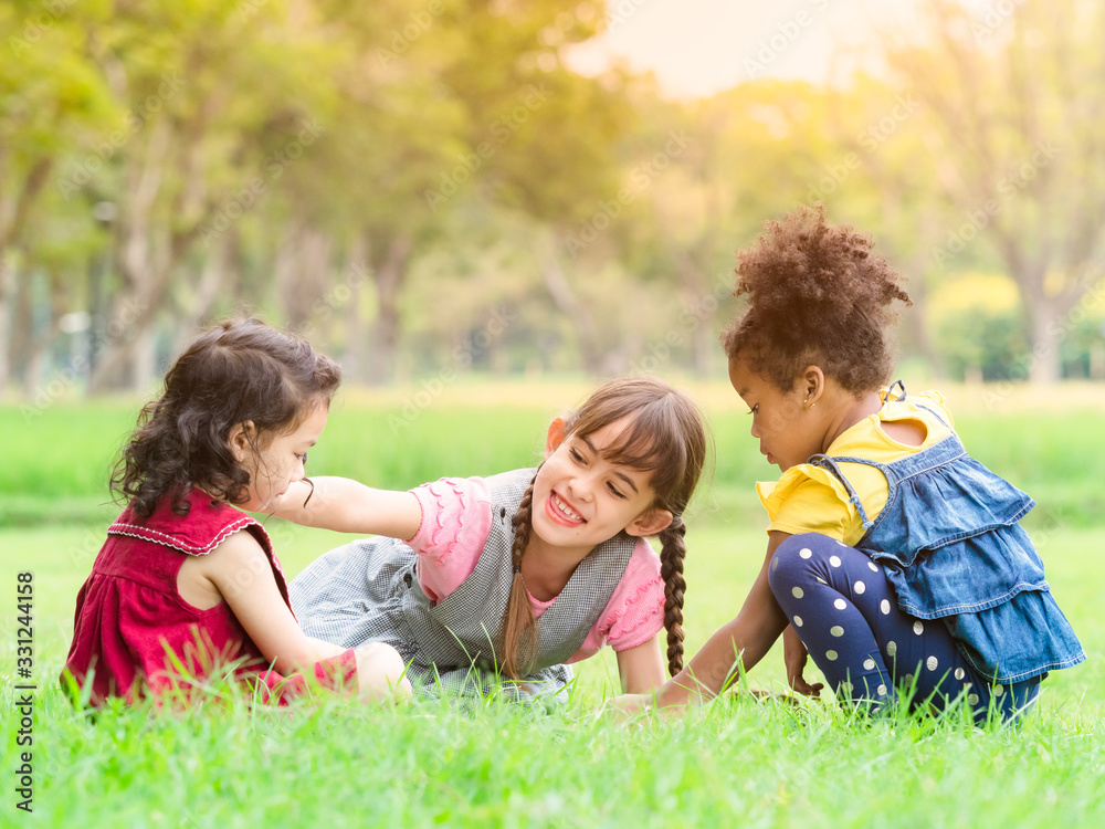 A group of young children of many nationalities play and learn outside of school