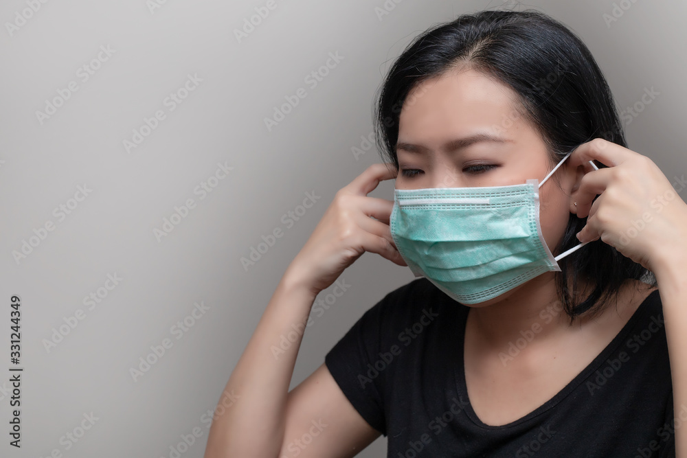 Portrait of Asian woman wearing surgical mask for protecting COVID-19 or epidemic disease. Portrait of Asian woman wearing surgical mask for protecting COVID-19 or epidemic disease.