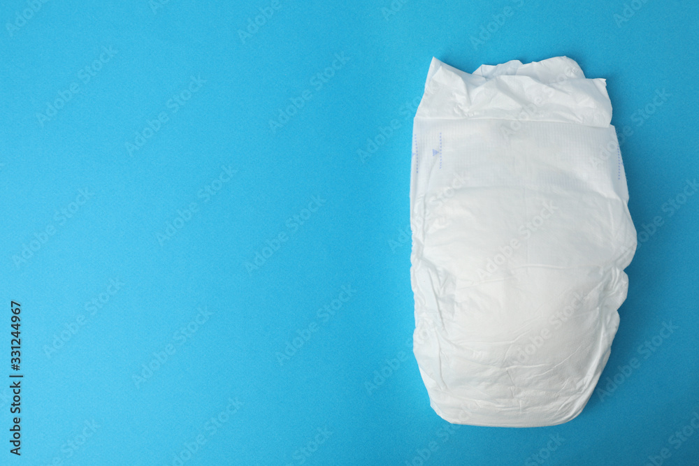 Baby diaper on blue background, top view. Space for text Baby diaper on blue background, top view. Space for text