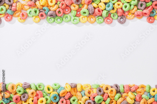 top view of bright multicolored breakfast cereal on white background