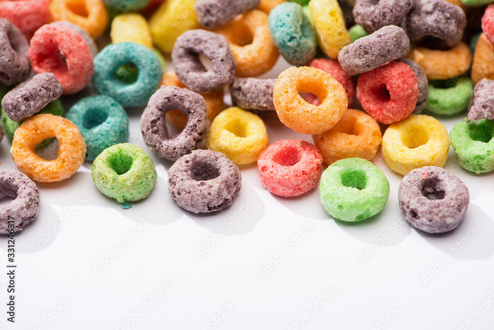 close up view of bright multicolored breakfast cereal on white background close up view of bright multicolored breakfast cereal on white background